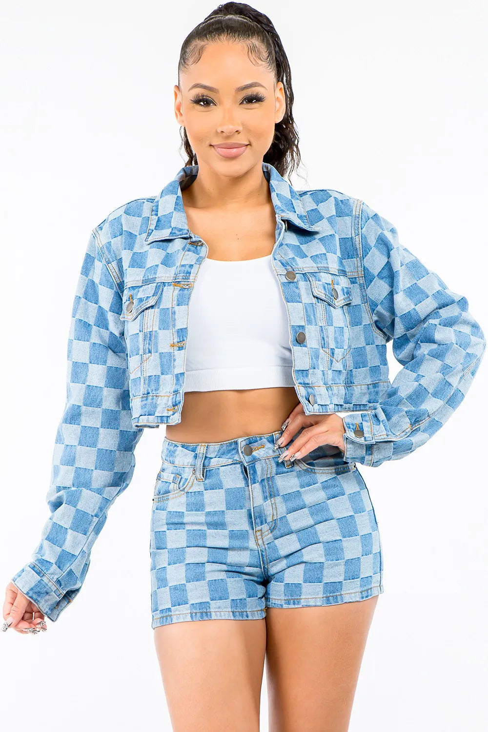 A woman wearing a Checkered Long Sleeve Cropped Denim Jacket with white T-Shirt and checkered denim shorts. 